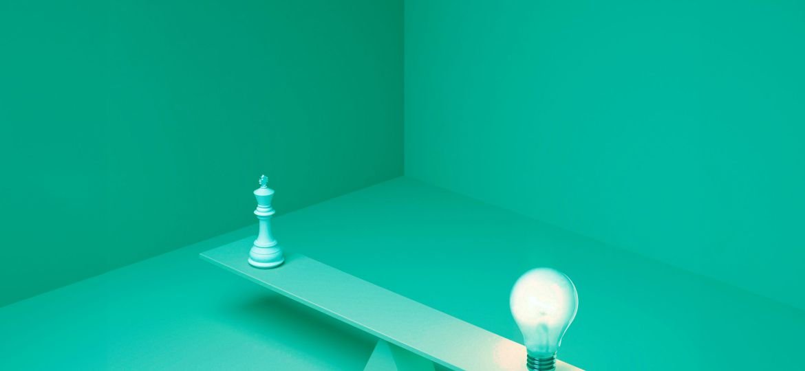 lit-lightbulb-balancing-plank-chess-piece-as-idea-concept